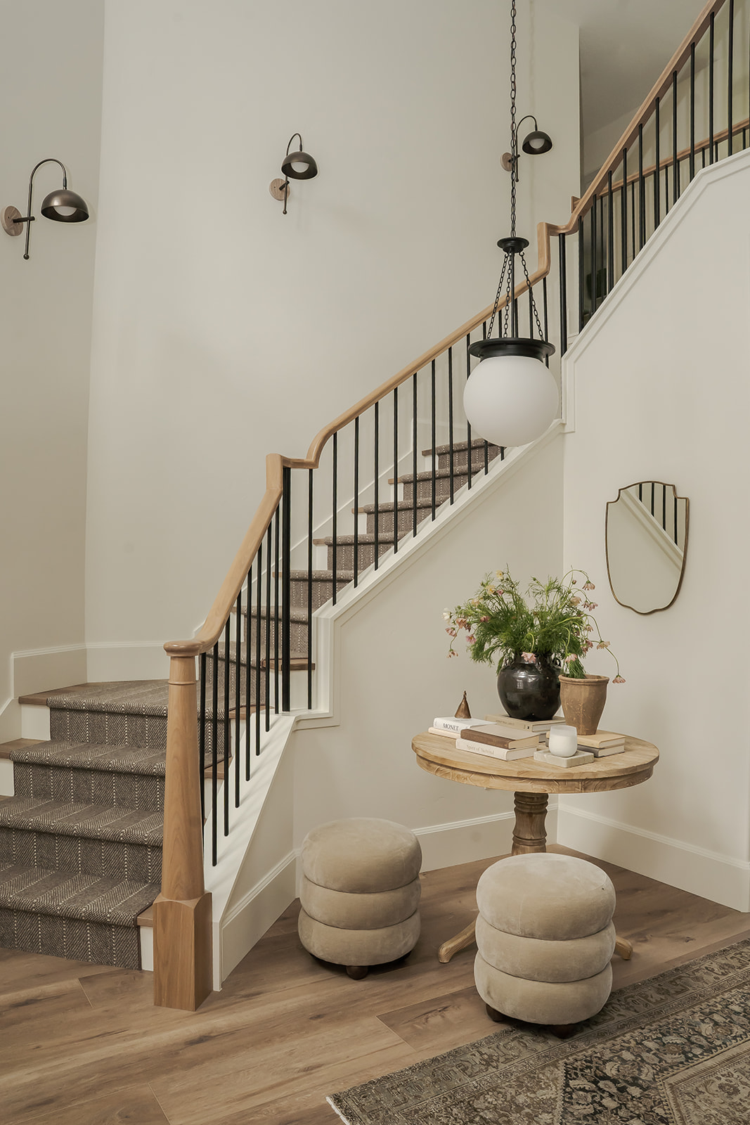 Entry stairwell with oak handrail, iron balusters and pendant lantern