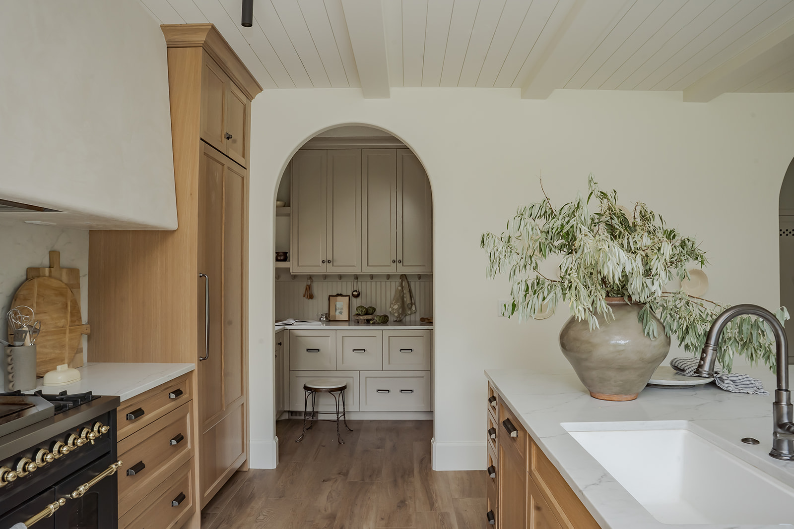 Kitchen with arched pantry opening and marble countertops