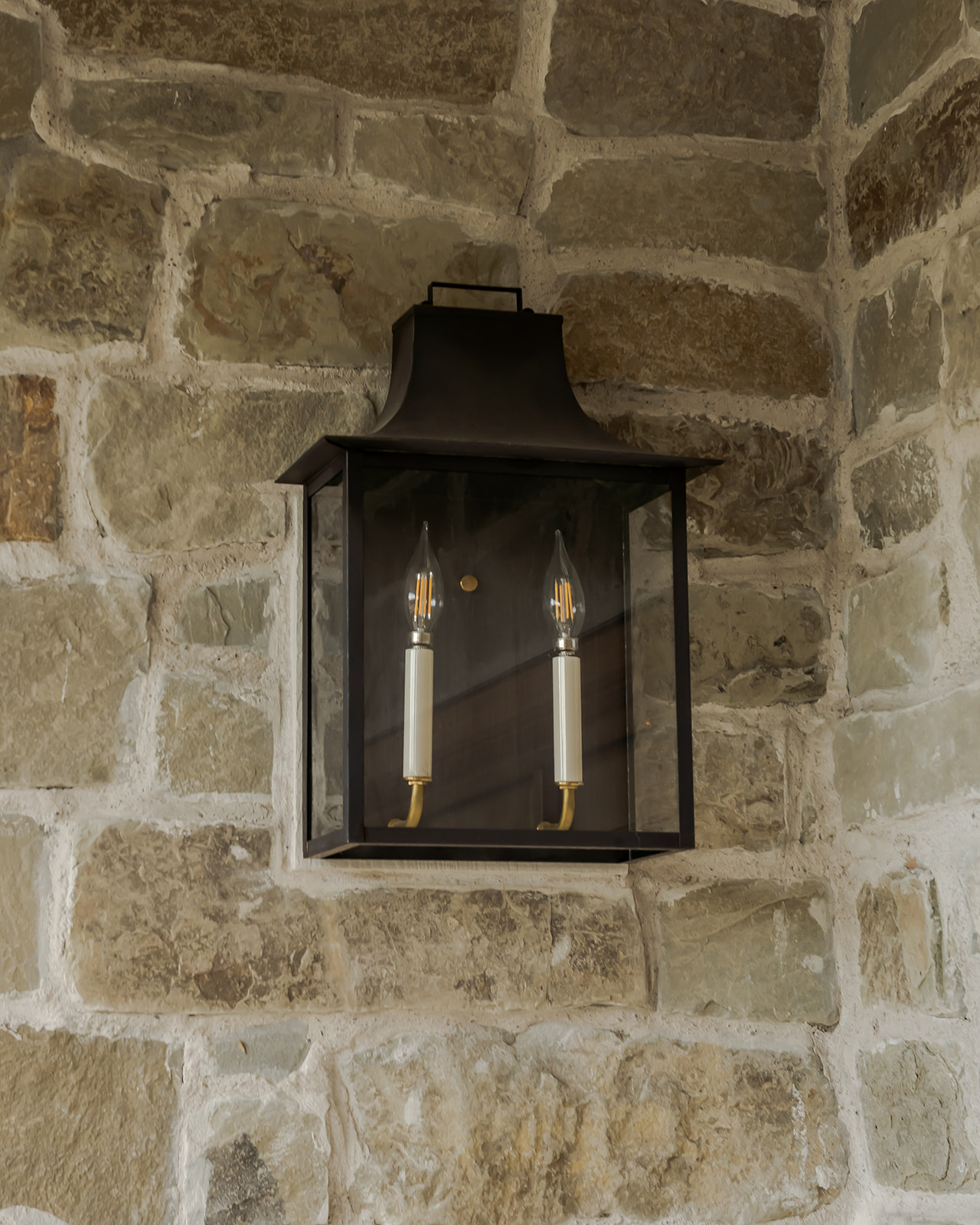 Exterior lantern on stone wall